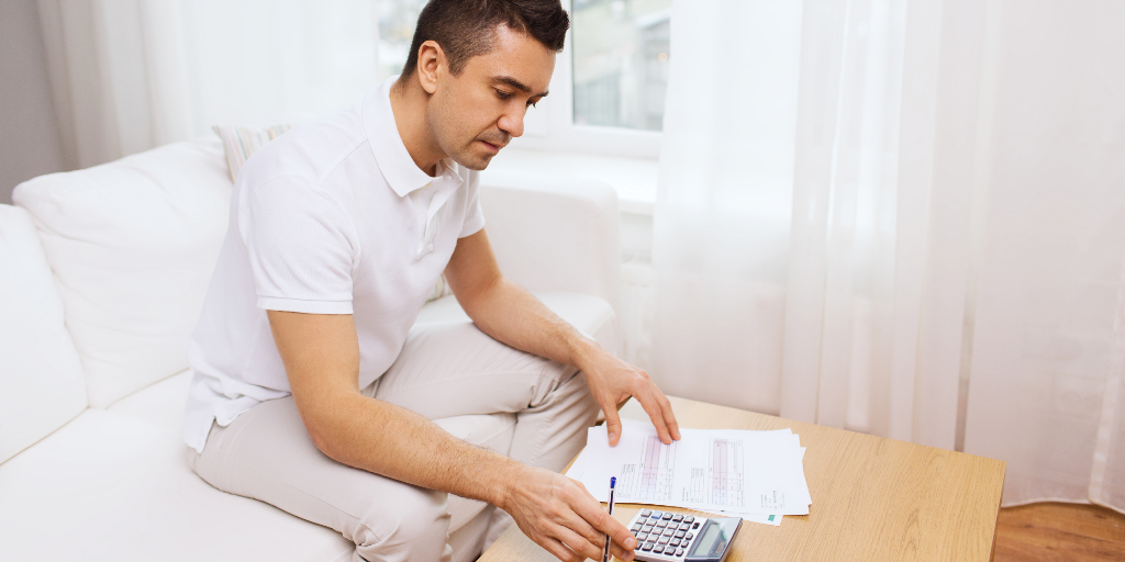 man calculating his expenses using the zero-based budget