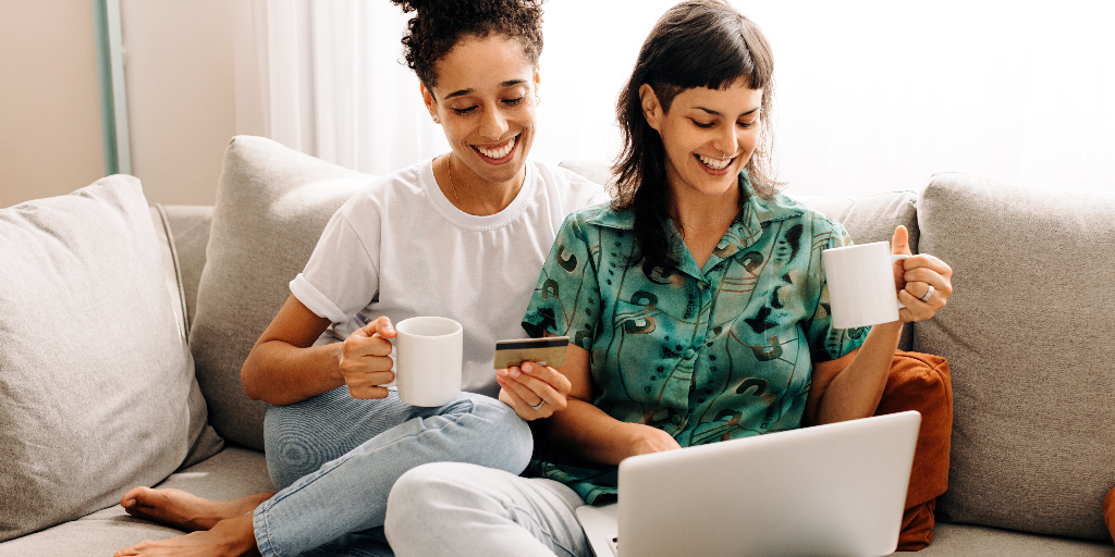 Two women looking at their credit card account to evaluate their credit score
