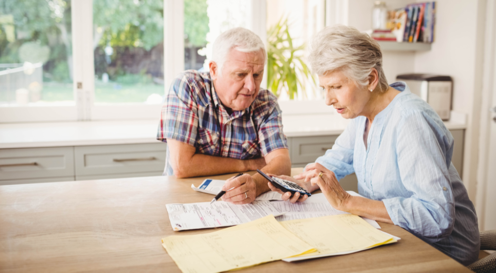 old couple looking at bills