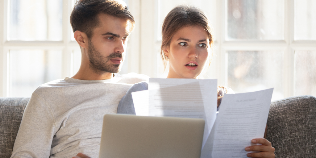 Couple looking at debt collection report