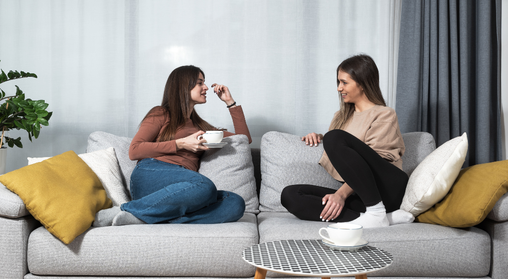 women talking on couch